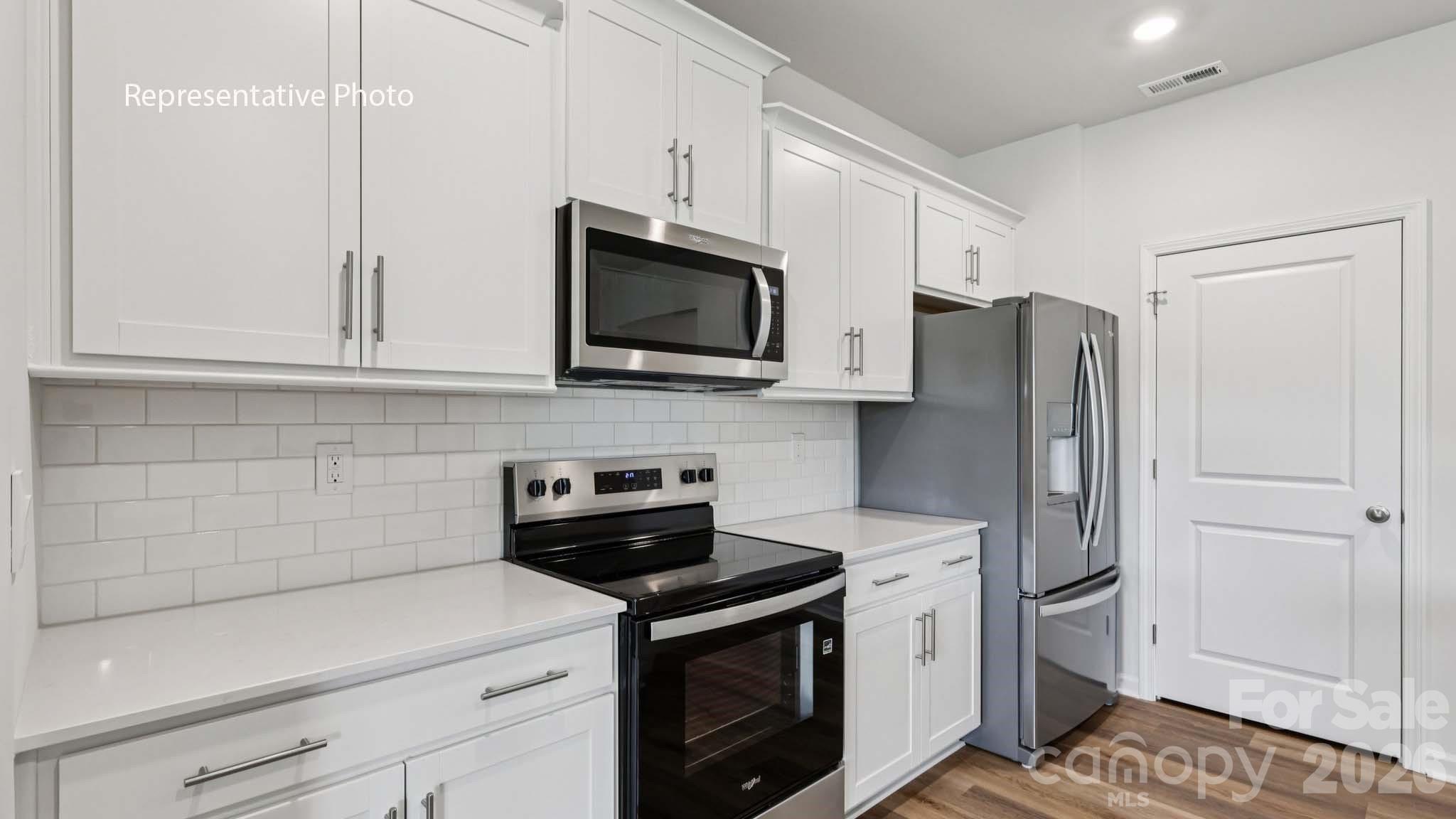 7608 Bainbridge Road Sherrills Ford, NC 28673 - Photo 13 of 28 a kitchen with stainless steel appliances white cabinets and a stove