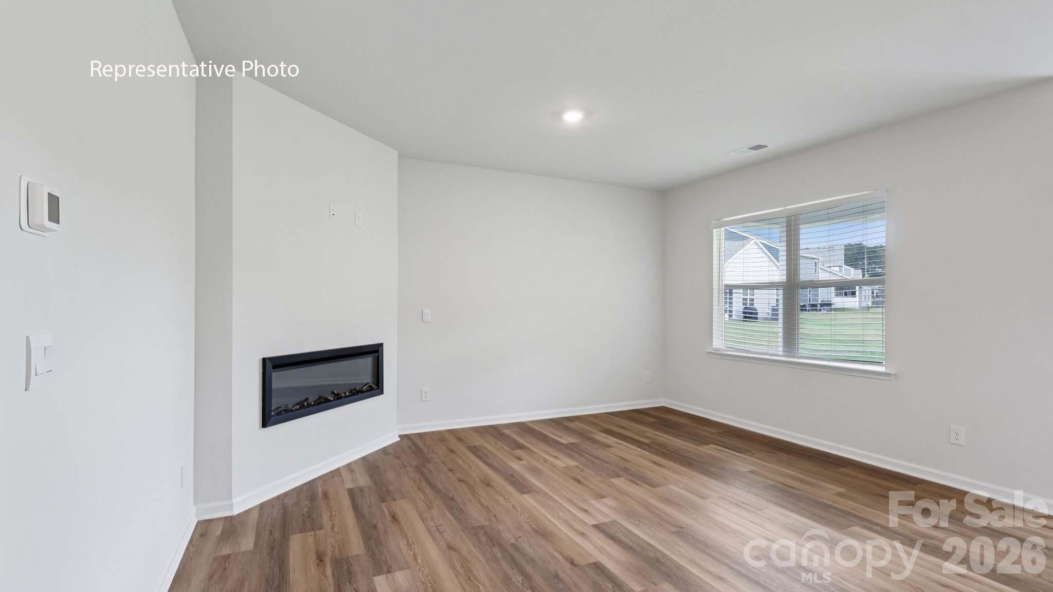7608 Bainbridge Road Sherrills Ford, NC 28673 - Photo 2 of 28 a view of an empty room with a window and wooden floor