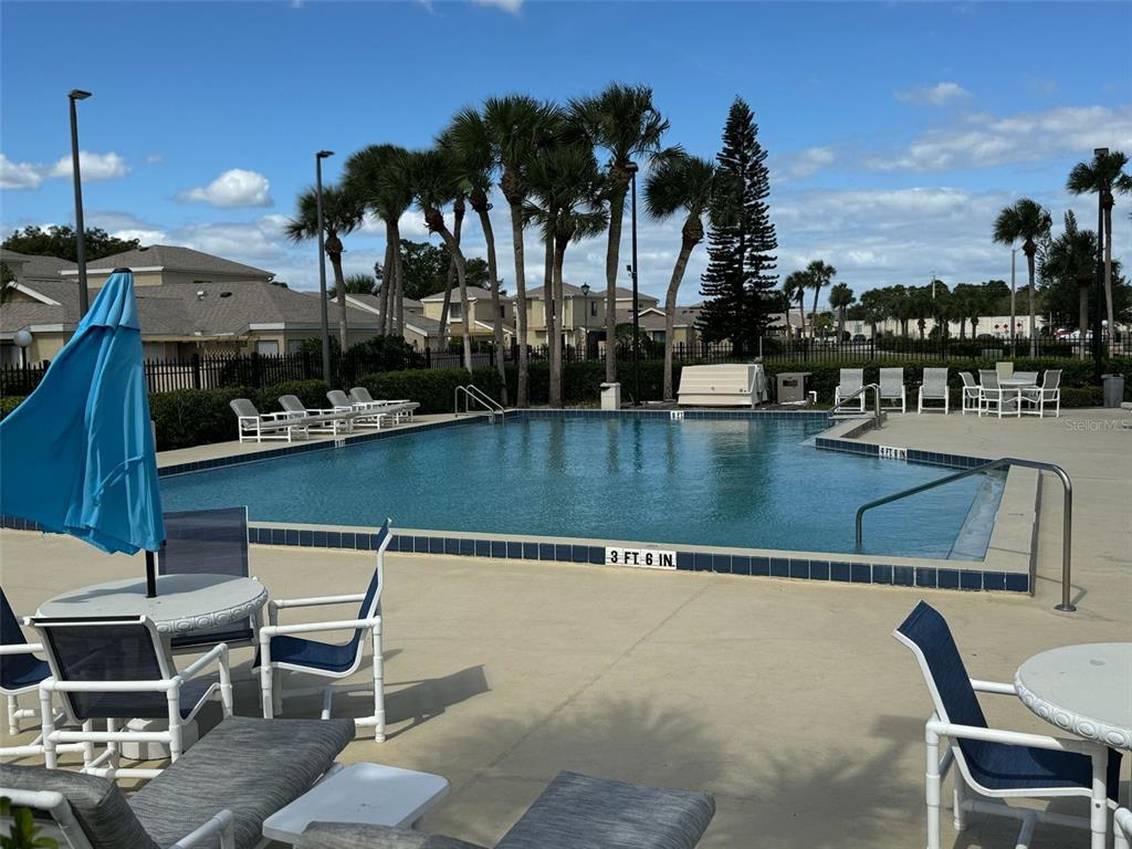 1030 Abada Court Northeast, Unit 110 Palm Bay, FL 32905 - Photo 13 of 14 a view of swimming pool with outdoor seating