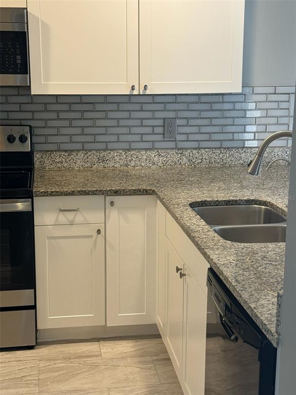 1030 Abada Court Northeast, Unit 110 Palm Bay, FL 32905 - Photo 7 of 14 a kitchen with a sink and cabinets