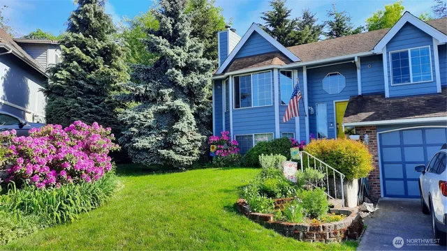 a front view of a house with a yard and fountain