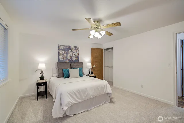 a bedroom with a large bed and a chandelier