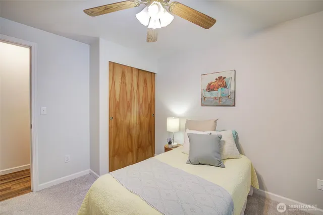 a bathroom with a granite countertop sink a large mirror and a shower