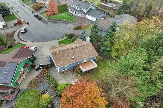 an aerial view of residential house with outdoor space and parking