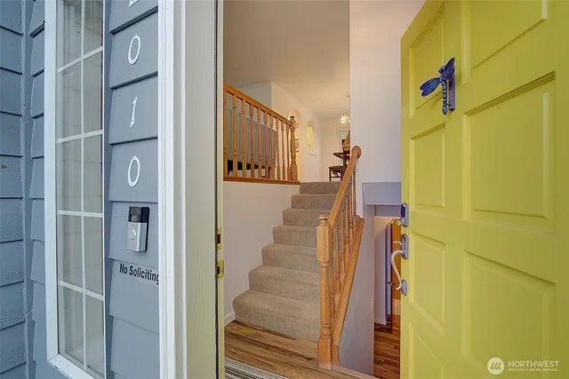 a view of hallway with wooden floor and staircase