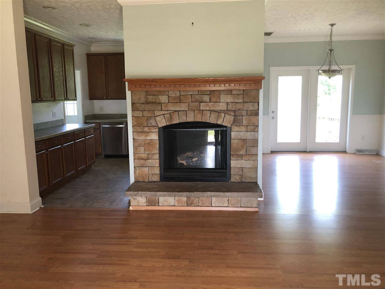 330-j B J B Leonard Road Castalia, NC 27816 - Photo 4 of 9 a living room with hard wood floors and a fireplace