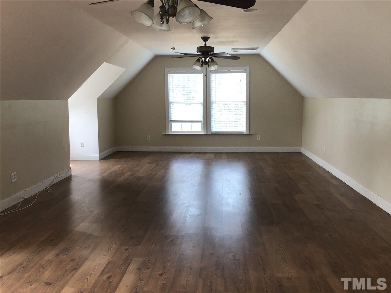 330-j B J B Leonard Road Castalia, NC 27816 - Photo 6 of 9 an empty room with wooden floor chandelier fan and windows