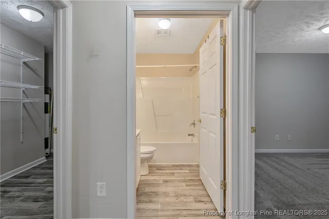 a view of a bathroom from a hallway