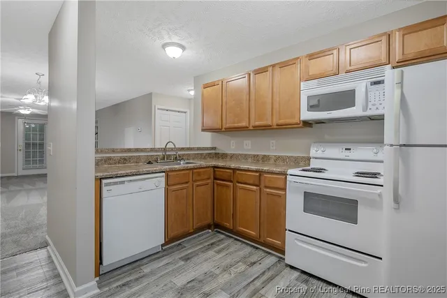 a kitchen with stainless steel appliances granite countertop a stove and a sink