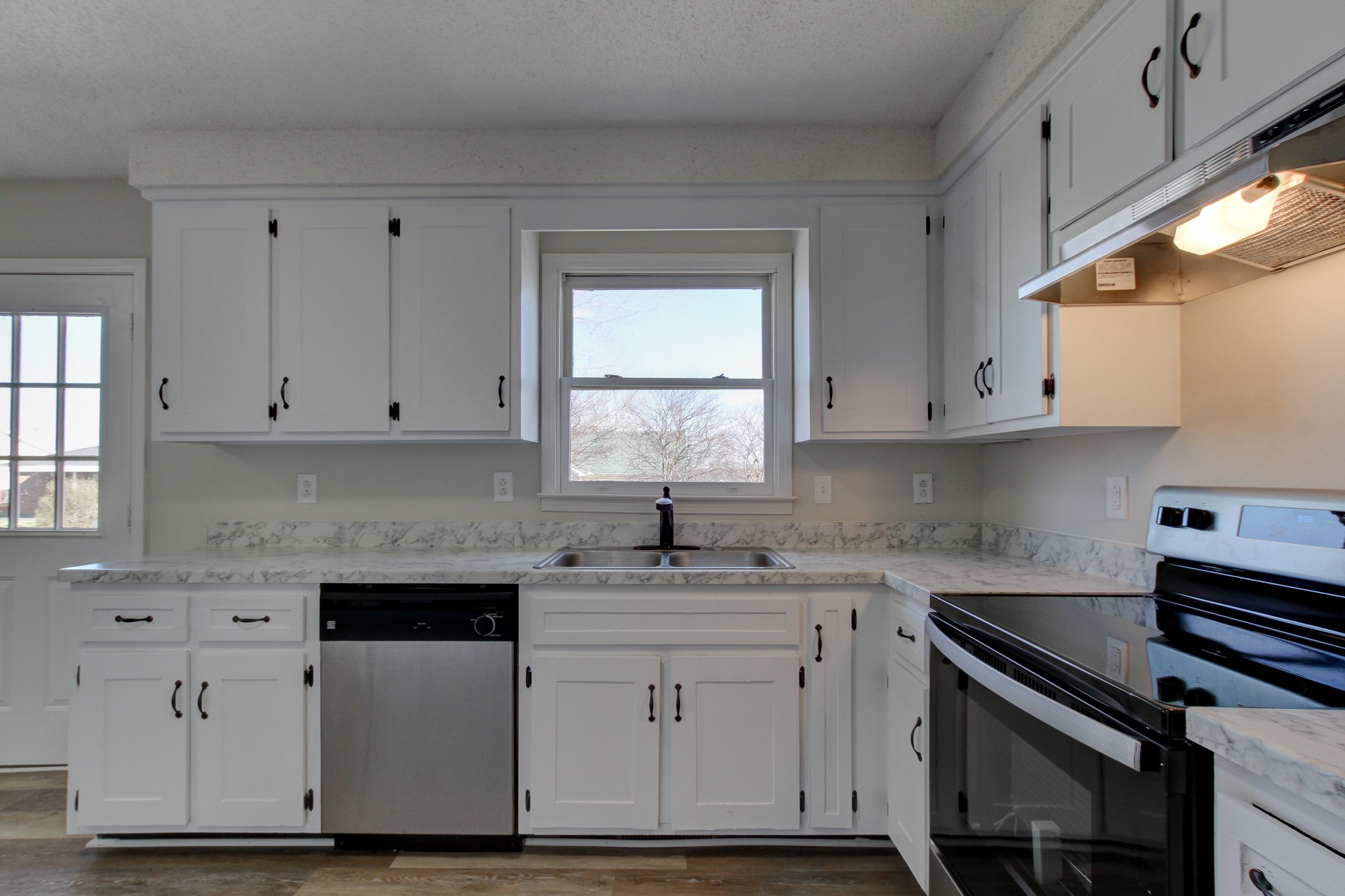 1007 McClardy Road Clarksville, TN 37042 - Photo 13 of 34 a kitchen with white cabinets and white appliances