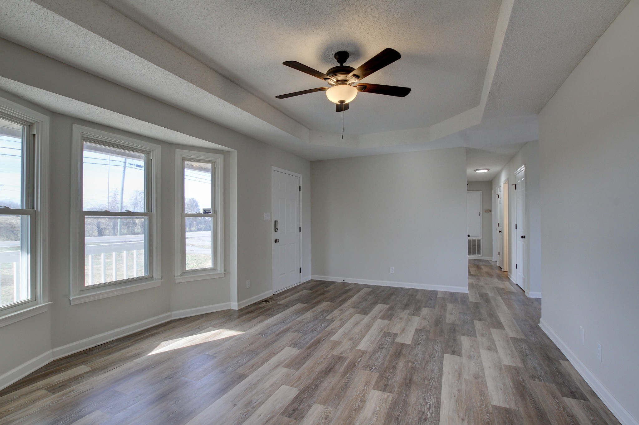 1007 McClardy Road Clarksville, TN 37042 - Photo 7 of 34 a view of empty room with wooden floor and fan
