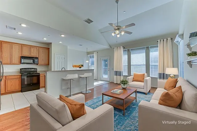 a living room with furniture kitchen and a fireplace