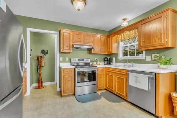 a kitchen with stainless steel appliances granite countertop a stove and a refrigerator