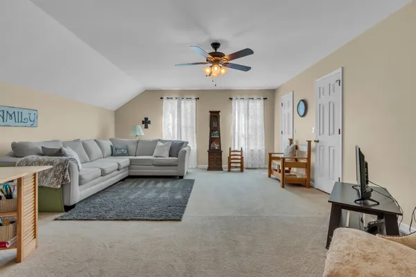 a living room with furniture and a chandelier