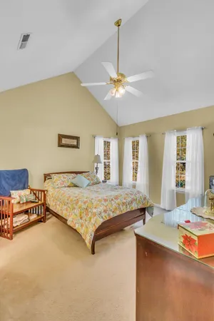a bedroom with a bed and ceiling fan