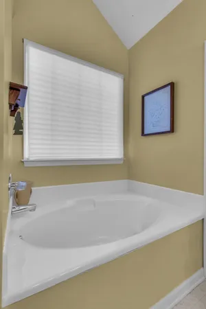 a bathroom with a bathtub and a window
