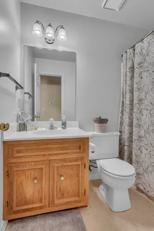 a bathroom with a toilet sink and mirror