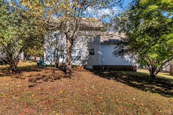a backyard of a house with a large tree