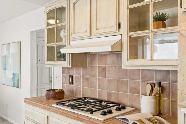 a dining room with furniture a window and potted plants