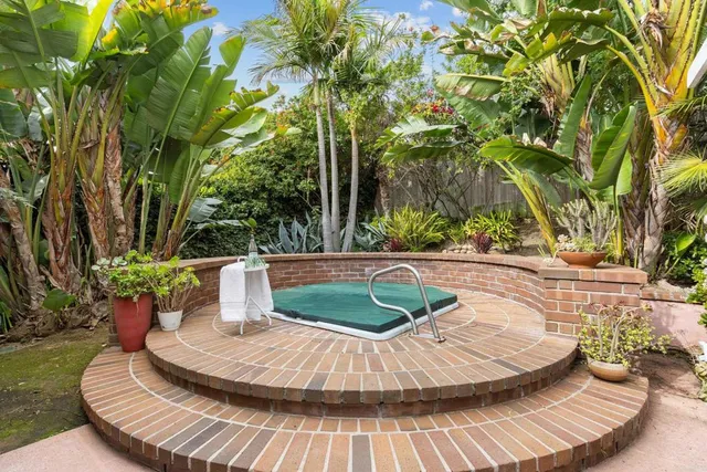 a view of a house with backyard sitting area and garden