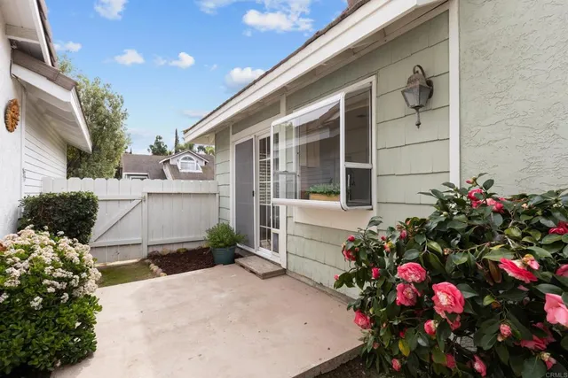 an aerial view of residential building with parking and yard