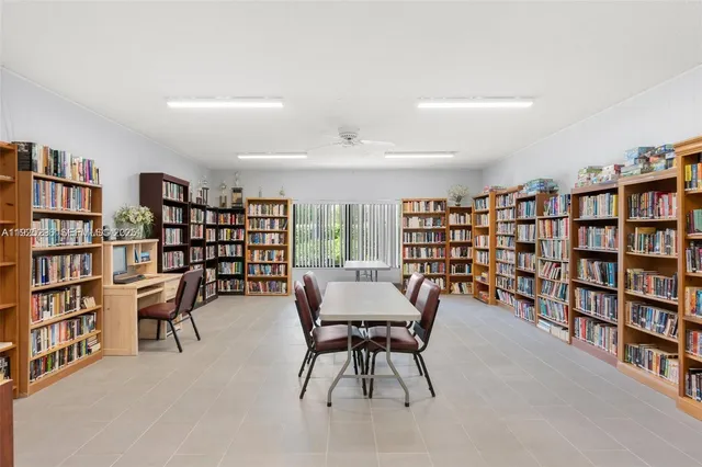 a view of a livingroom with furniture and bookshelf