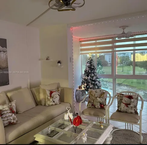 a living room with furniture and a floor to ceiling window