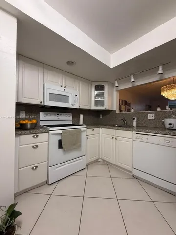 a kitchen with appliances cabinets and a sink