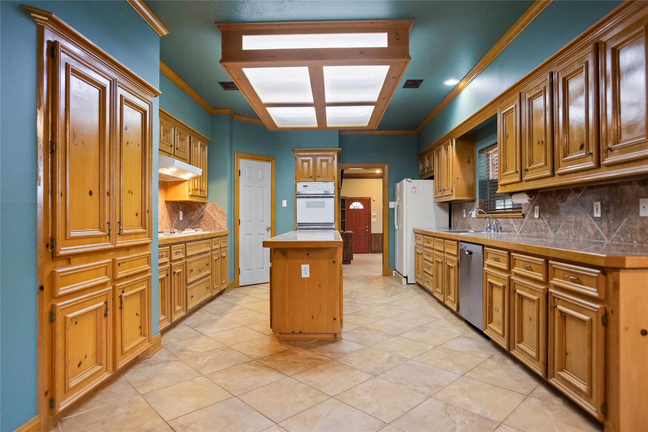 22916 East Martin Drive Porter, TX 77365 - Photo 8 of 43 a kitchen with stainless steel appliances granite countertop a refrigerator a sink dishwasher stove and oven with wooden cabinets