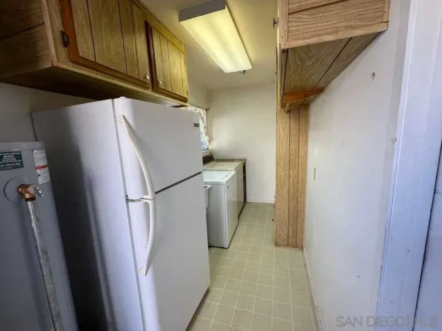 a white refrigerator freezer and a stove sitting inside of a kitchen