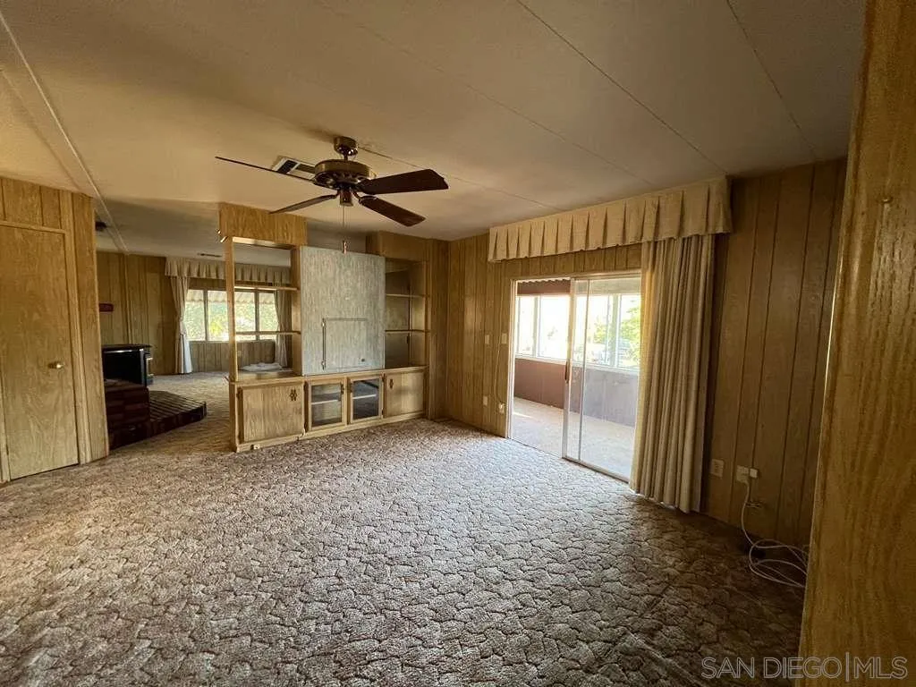 101 Jones Street Bodfish, CA 93205 - Photo 2 of 16 a view of a livingroom with a flat screen tv ceiling fan and windows