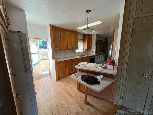a kitchen with stainless steel appliances a sink stove and refrigerator