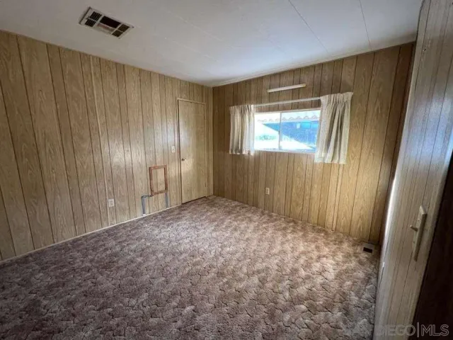 a view of an empty room with wooden door