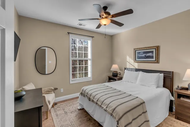 a bedroom with a bed and a chandelier