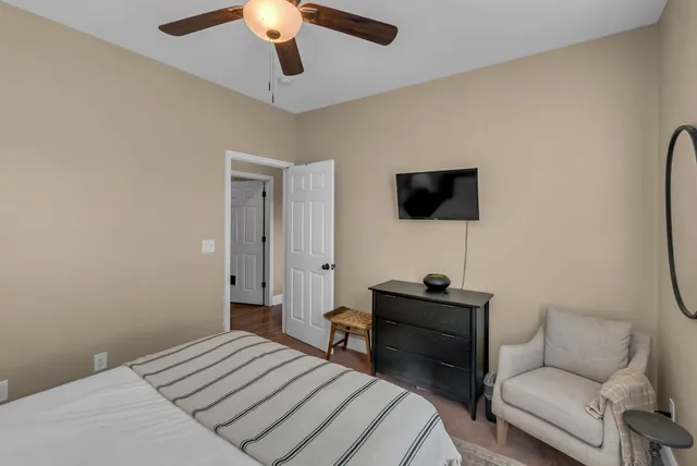 a view of an empty room with a window and hardwood floor