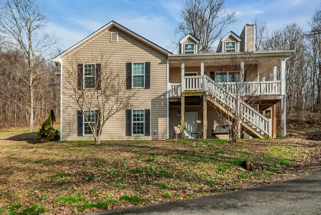 a view of house with a yard
