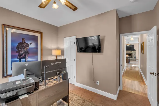 a kitchen with stainless steel appliances kitchen island granite countertop a dining table chairs and white cabinets