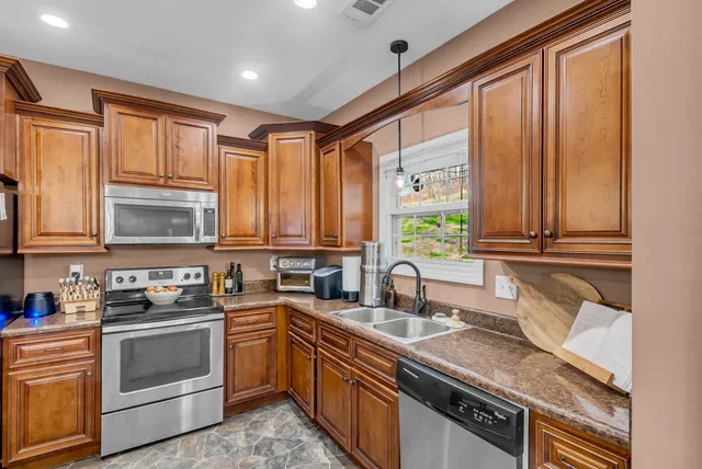 a view of a dining room with furniture and a chandelier