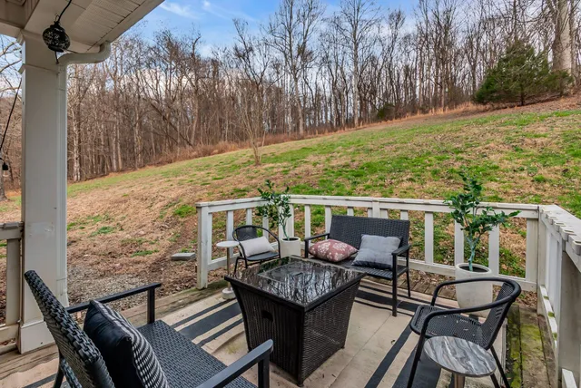 a view of a house with a yard and trees