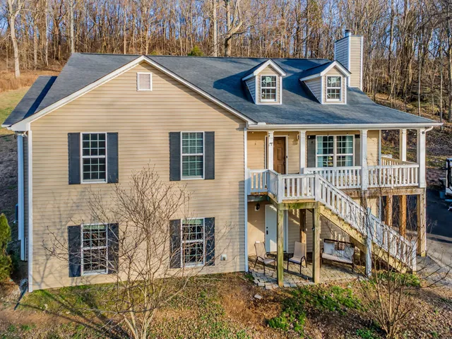 a view of a patio with table and chairs near a large tree