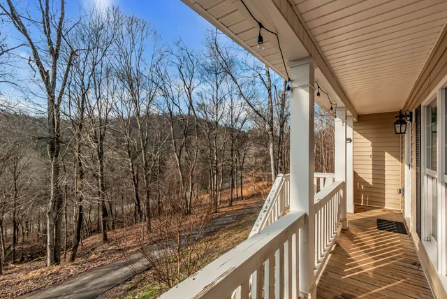 a view of balcony with wooden floor and fence