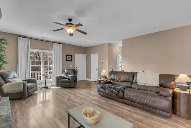 a living room with furniture and a chandelier