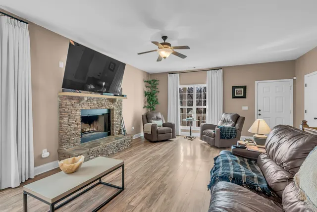 a living room with furniture fireplace and a flat screen tv