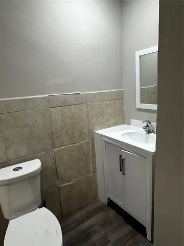 a bathroom with a sink toilet and a mirror
