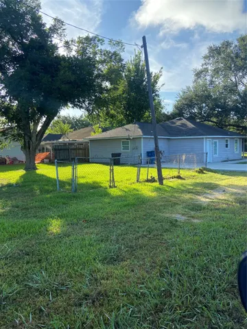 a view of a backyard with swimming pool