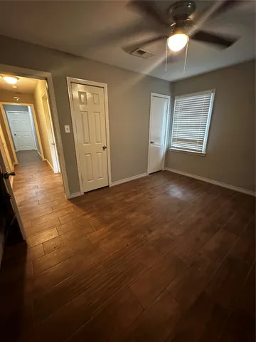 a view of an empty room with a fireplace and a window
