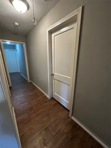 an empty room with wooden floor and closet