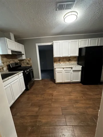 a kitchen with a stove a refrigerator and a sink