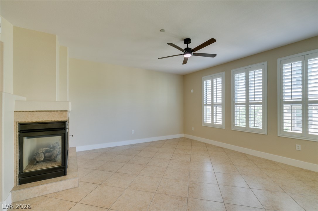 2555 Hampton Road, Unit 3203 Henderson, NV 89052 - Photo 11 of 43 Tiled flooring and plantation shutters accent this versatile living space featuring a corner fireplace.
