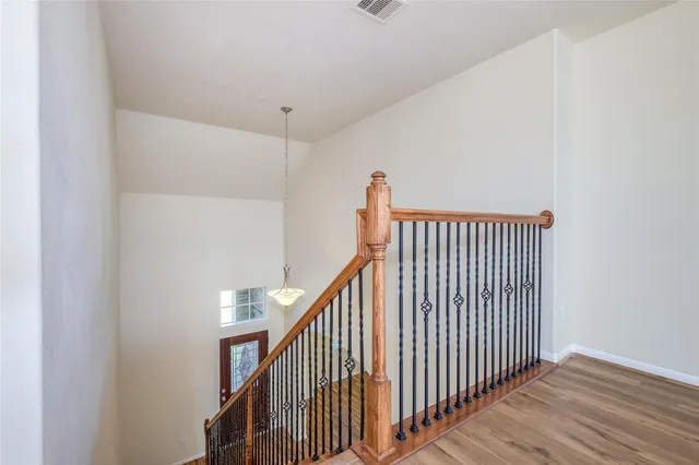 a view of staircase with railing and white walls